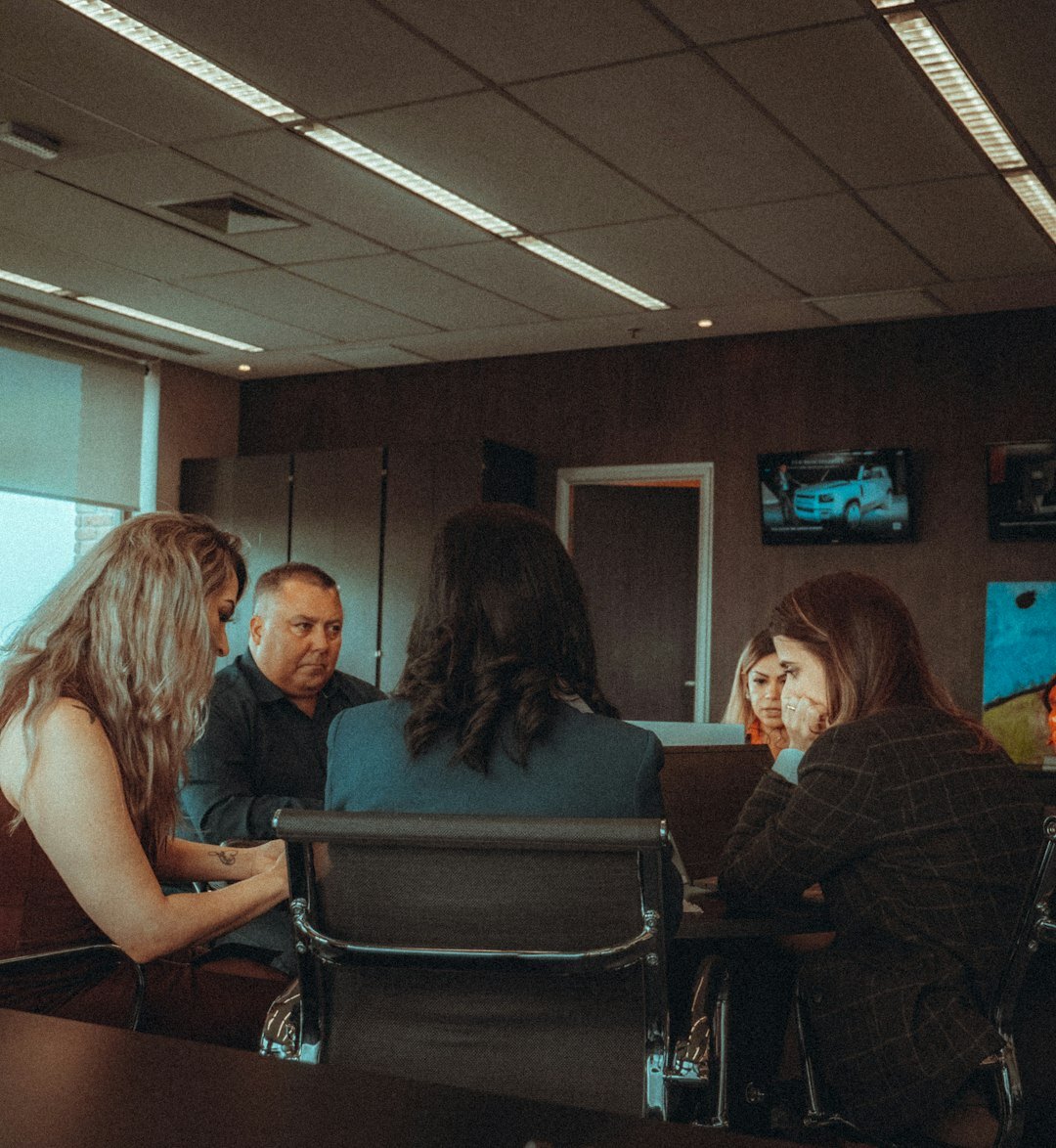 Diverse team of editors working together around a table in a bright office