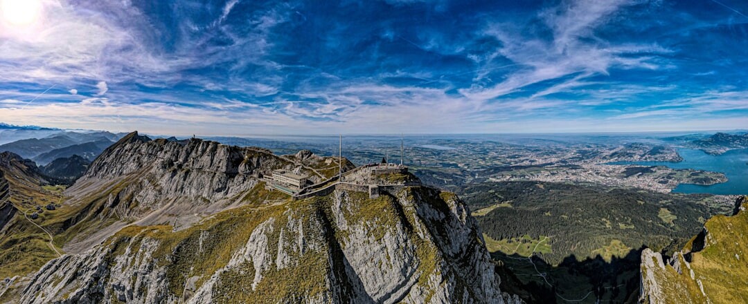 Panoramic view of a Swiss alpine lake surrounded by mountains at golden hour
